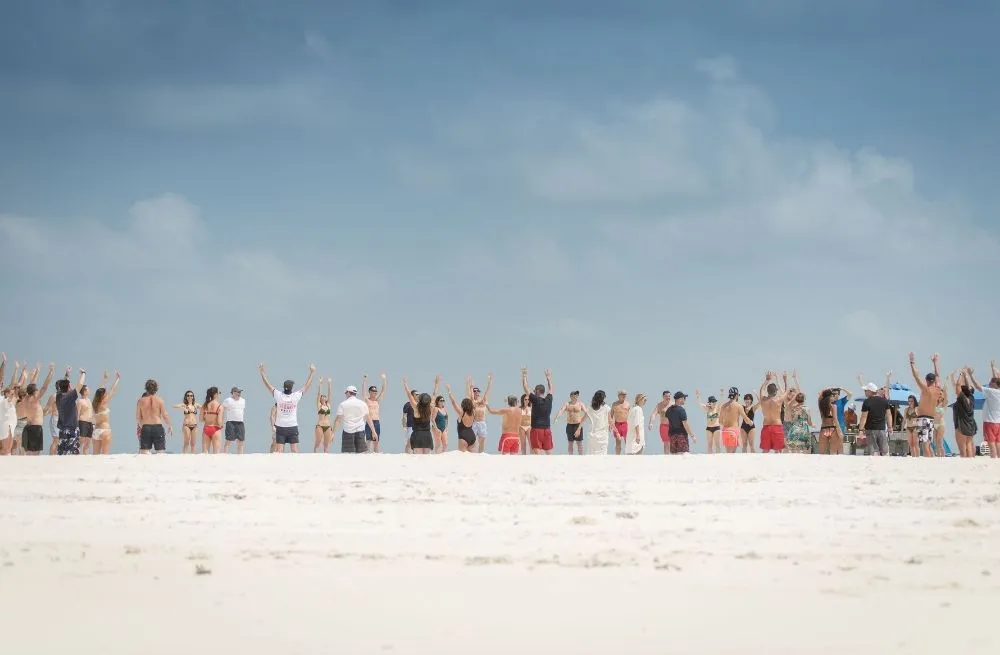 Guests celebrating together on a Maldives sandbank