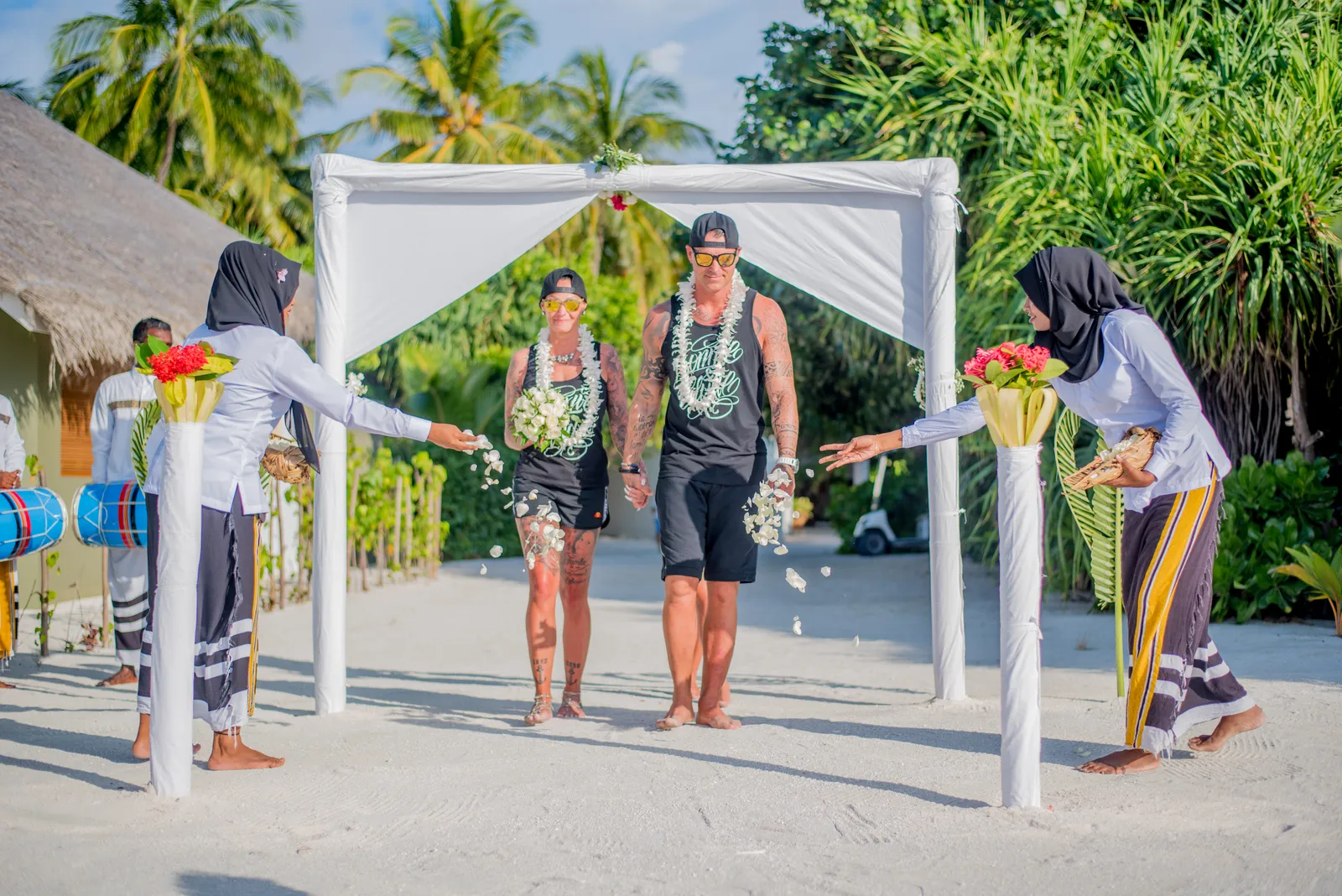 Family celebrating at a Maldives beach wedding at sunset